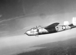 B-25H, "Wabash Cannonball", of the 491st Bomb Squadron in flight over China. Notice the 'smudge' behind the squadron emblem and below the pilot's side window. The smudge is the residue of the powder from when the side-mounted .50 caliber machine guns, are fired during a low-level attack on trains, rail yards, bridges, convoys, barges, troops, etc.  From the collection of Wozniak, combat photographer for the 491st Bomb Squadron, in the CBI.