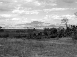 Beautiful rural scenery in Yunnan province, China, near Yangkai, during WWII, taken by Eugene Wozniak, showing an attractive tower in the plain.