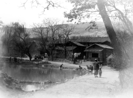 Ladies washing clothing in a village pond near Yangkai, Yunnan province, China. During WWII.