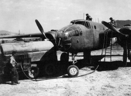 Men refueling a B-25 bomber in SW China. During WWII. The aircraft's wheel has been painted with "AJR" for Air Jungle Rescue.