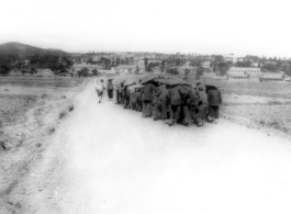 Chinese laborers move a heavy object, possibly a cement roller. During WWII. In SW China.