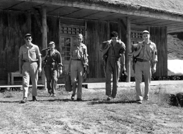 American flyers at Guilin, China, set forth with their gear towards the flight line during WWII.  From the collection of Hal Geer.