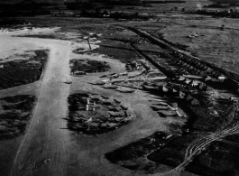 L-6s, and other planes at the Liuzhou (Liuchow) air base during the summer or fall of 1945. Rows of tents are on the right. The distinct karst mountains of the area are visible in the background.  Photos taken by Robert F. Riese in or around Liuzhou city, Guangxi province, China, in 1945.