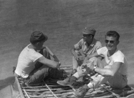 GIs and Chinese soldiers float on a sheep-skin raft in northern China, probably on the Yellow River. During WWII.