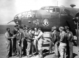 Left-right, William 'Bill' Byran shakes hands with Capt Robert Ebey (pilot), who hides Capt William DeVries (engineering officer) , Lt. Hilliard Ebey (nav), Lt Paul Sjoberg (copilot), Lt George Jernigan (bombardier) shakes hands with M/Sgt Cecil ' Bo' Noe (line chief) with Sgt Donnely (radio) looking on, S/Sgt Lyle Wilson, Pete Bertani, unknown, Capt Joseph Peterson, S/Sgt Rudolf Madsen (tail gunner).  From the collection of Frank Bates.