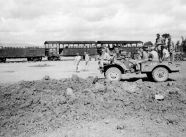 Kealy, Johnny Burns, Schmidt, Hammett, Alexander, Nash, Nyreen, Alelunas, Sam Knox, Liuzhou, September 1944. Train in the background is full of barrels of fuel. The disturbed ground in the foreground is likely caused by bombing.  From the collection of Frank Bates.