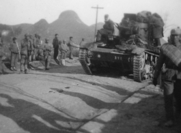 Marching Nationalist troops and an Nationalist tank Chinese armored tank (possibly a soviet T-26b) on the road in southern China. During WWII.