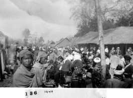 "Village scene in Mengsa or Szemao" in SW China, in 1944, during WWII. Likely market day activities.