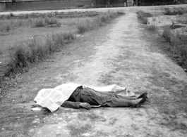 "Yunnan (China), shrouded corpse of houseboy executed for theft." During WWII in SW China. 