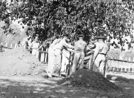 Solemn burial ceremony for American GIS who had died at a temporary war-time graveyard. In the CBI, during WWII.