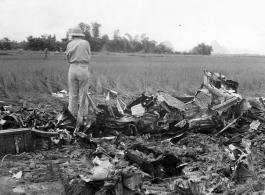 GIs look over devastating crash site of an American aircraft--the bent .50 cal machine gun in one image indicates it is American, and the gun mounting is like that of the nose gun of some B-25 Mitchells.  In this image set, the intensity by which people are searching the crash site, and the solemn nature of it all, makes one wonder if they are not looking for human remains.