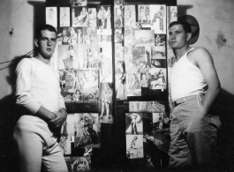 View inside barracks for two GIs in Yunnan, China, during WWII--here a wardrobe covered in pin-up girls.