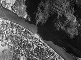 Bombing of small riverside town likely in SW China (esp. Guangxi), but possibly in Burma, or French Indochina. During WWII.