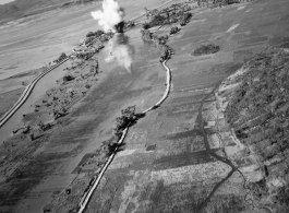 Bombing of small rail bridge, among a flood plain, in French Indochina during WWII.