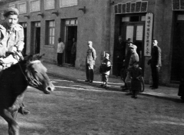 American Navy GI riding a mule in a small town in Northern China, Shaanba Town, Inner Mongolia.  内蒙陕坝市。