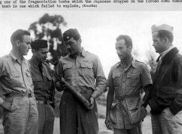 American GIs examine small Japanese fragmentation bomb in China on November 13th, 1942.  2nd Lt. Nicholas Marich (sometimes spelled Marick) and 2nd Lt. Joseph W. Cunningham returned to American bases after having spent three days behind Japanese lines evading capture after their B-25 bomber was shot down on October 25, 1942 about 25 miles north-west of Hong Kong, China. They were only two of six crew who escaped (1st Lt. Howard C. Allers, 2nd Lt. Murray L. Lewis, Sgt. Paul C. Webb, and Sgt. James N. Young w