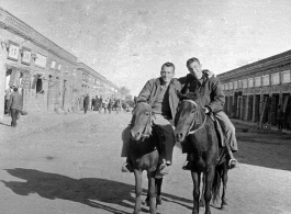 SACO men on mules on the street in Shaanba (陕坝镇), Inner Mongolia, China, during WWII.