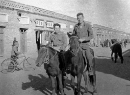 SACO men on mules on the street in Shaanba (陕坝镇), Inner Mongolia, China, during WWII.