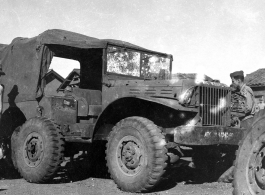 Men repair a damaged ATC ground transport vehicle, damaged by shrapnel or bullets. In China during WWII.