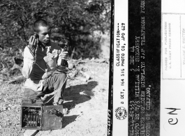 Chinese soldier displays Japanese telephone found north of Zhefang.  December 5, 1944.  Photo by T/5 William E. Shemorry. 164th Signal Photographic Company, APO 627.  Passed by William E. Whitten.