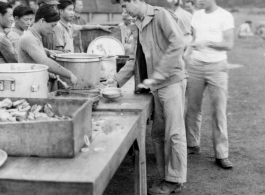 GIs line up for food distributed by Chinese staff, while enjoying AAF Day celebrations, August 1, 1945, at Yangkai, APO 212, during WWII.