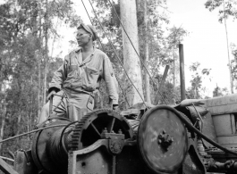 GIs moving logs using spar tree in Burma.  During WWII.  797th Engineer Forestry Company.