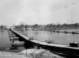 797th Engineer Forestry Company in Burma: Enormous floating bridge over a river on the Burma Road.  During WWII.