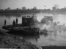 Bulldozer on ferry on river in Burma.  During WWII.  797th Engineer Forestry Company.