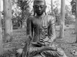 Bronze Buddha inside remains of Buddhist temple in Burma.  During WWII.