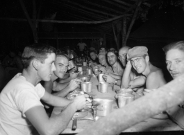 Engineers of the 797th Engineer Forestry Company eating meal at camp in Burma.  During WWII.