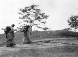 Women carry packs at Darjeeling, India, during WWII.