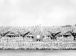 Personnel of the 9th Bombardment Squadron, 7th Bombardment Group, 10th Air Force, pose covering a B-24 bomber during WWII.