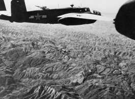 View from B-25s of the 22nd Bombardment Squadron in flight over SW China, Indochina, or Burma during WWII--Happy for the rare escort by P-38s and P-51s.