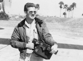 Aerial Photographer Earnest Jones, holding camera.