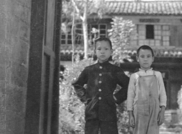 Local boys stand in the entry to a courtyard at Chanyi (Zhanyi) during WWII.