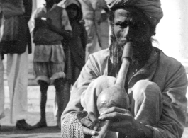 Snake charmer in India, during WWII.