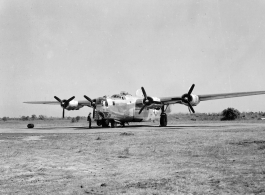 Loading film into 24th Mapping Squadron F-7A, #441678, from photographic equipment carrying trailer. February 22, 1945.