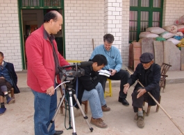 Mr. SU, and Mr. LUCAS interview old timers in the village.  This home is only a few meters from the pond where the remains rest.  Mr. HUANG Xiling video tapes.