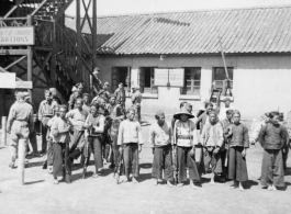 A Chinese and American search party being organized to find an American pilot whose plane had gone down in a location pinpointed by the 23rd Fighter Control Squadron, which was one of its duties.  The sign on the stairway in the background reads "Air Transport Command Operations."  From the collection of David Axelrod.