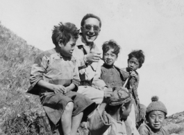 An American GI with Chinese kids in SW China during WWII.  From the collection of David Axelrod.