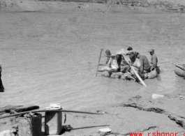 Men ride sheep-skin raft in northern China during WWII, most likely on Yellow River.