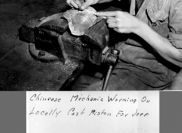 A Chinese mechanic working on a locally cast piston for a jeep.