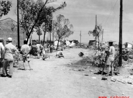 Retreat from Guilin, 1944.  This looks like engineers are planting mines before the Japanese enter the city.  Note the burned buildings in the background.