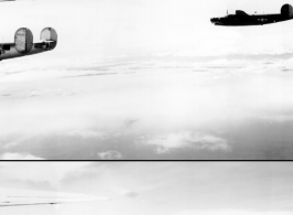 B-24 bombers in flight over water, with land in the background. Note the different paint scheme on the two planes, and shark teeth on the right plane.   Tail number 440780 on the left plane should make this "Red Hot Riding Hood," with the 374th Bombardment Squadron, 308th Bombardment Group.