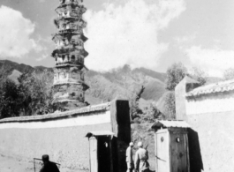 Nationalist troops and guard booths outside pagoda in Dali, Yunnan province, China, during WWII. This is one of three pagodas within a single walled compound. The compound a had been appropriated for use by Nationalist troops. Later, after the communist revolution, the compound was also used by troops, but by PLA troops.