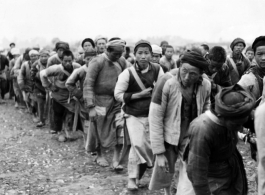 Chinese laborers pulling a large concrete rolling wheel at an air base somewhere in China.  Image from U. S. Government official sources.