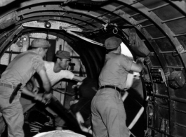 Men inside a US transport plane drop supplies from the air.10CU 6M20 2ND T.C. AIR SUPPLY SEC.