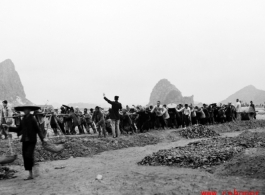 Chinese workers pulling a large roller at a base  in Guangxi province (probably Liuzhou, but maybe Guilin), China.