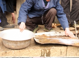 Images from January 14, 2008 visit to a WWII US crash site at Bamo township, in Tian\'e county, Guangxi province.     The extremely supportive villagers helping clean up a piece of aluminum airplane cladding, which ultimately revealed the part specification "ALCLAD 24S-T."