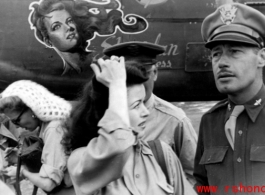 Ann Sheridan (white knitted hat) signs an autograph, with Ruth Dennis in the center foreground. Along with Mary Langdon and Ben Blue they were at Yangkai Air Base, China, on a USO tour in the CBI. In this photo they had just finished helping the 22nd Bomb Squadron dedicated their aircraft 'Sheridan Express' . John A. Johns (22nd B.S., deceased) painted the nose art just before Miss Sheridan arrived at Yangkai. After the war John became rather famous for his caricature art.